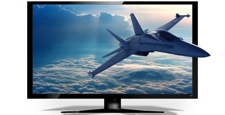 Foto: Fernseh-Bildschirm, aus dem ein Kampfjet rausfliegt; copyright:...