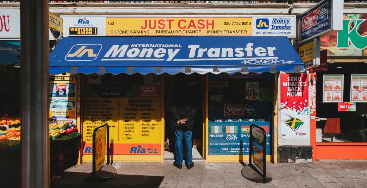 Money Transfer; Copyright: Alistair MacRobert/Unsplash...