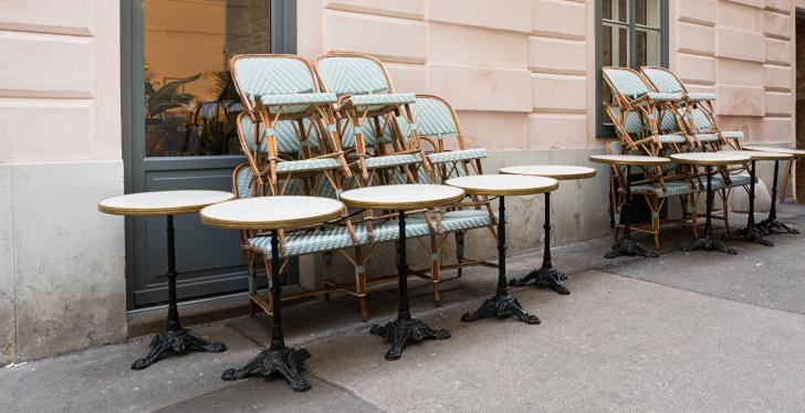 gestapelte Stühle vor einen geschlossen Restaurant...