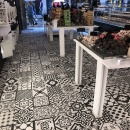 Ein gekachelter Boden mit schwarzweißen Mustern in einem Laden...
