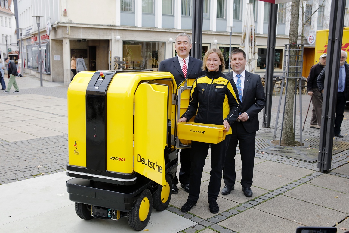 Zustell-Roboter hilft Postbotin bei der Arbeit